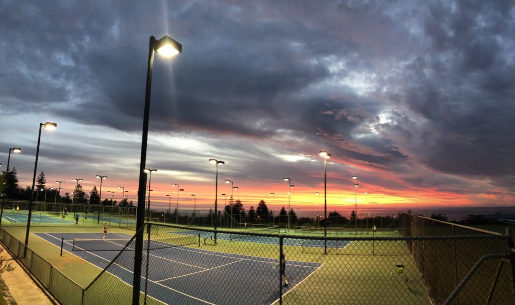 View of hard courts with sunset in the background