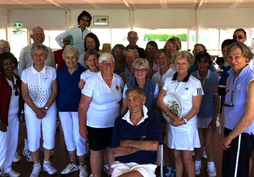 Birthday celebrations at the clubhouse, members stand facing camera