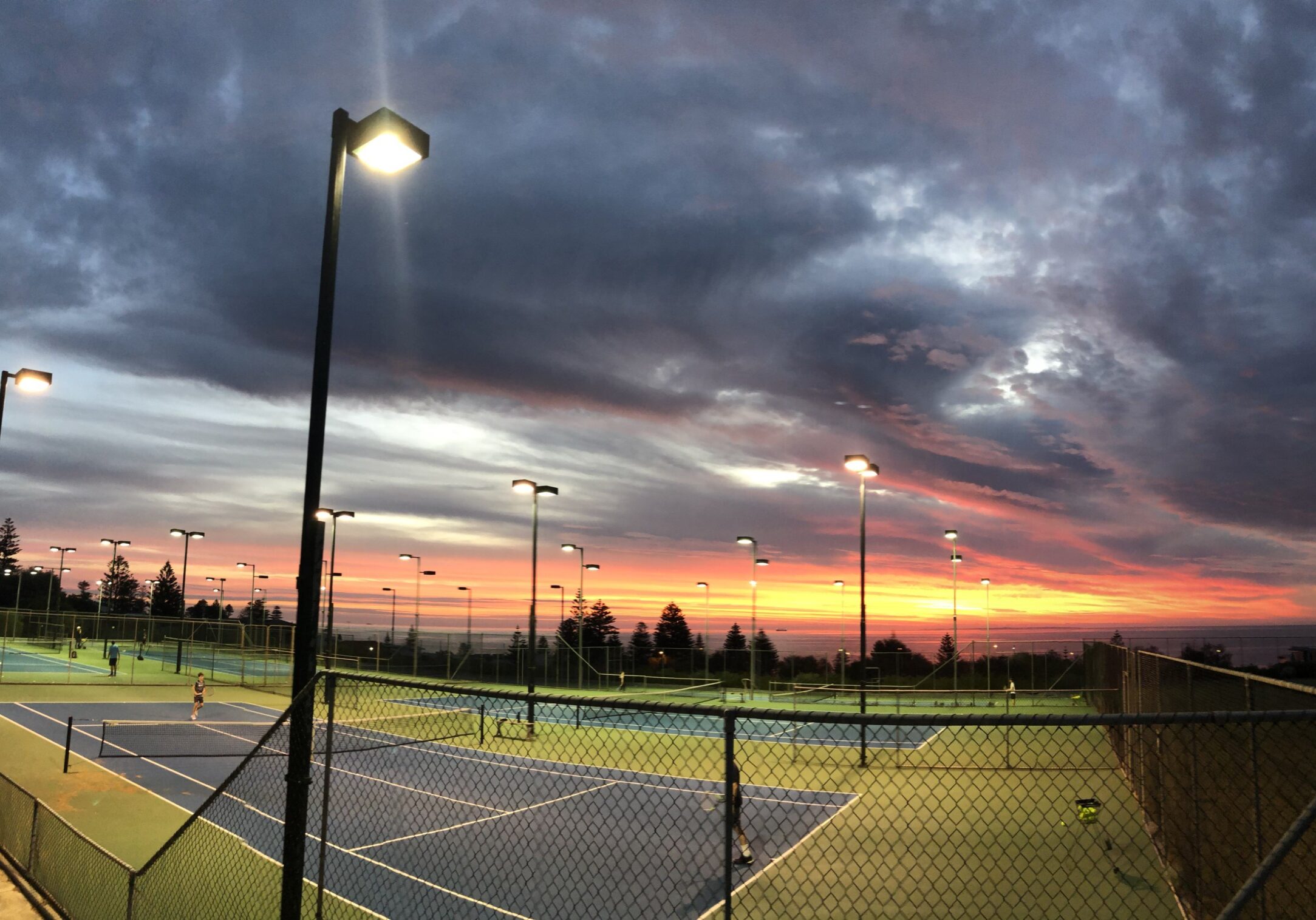 View of hard courts with sunset in the background